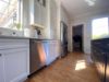 Warm Wood Floors Paired with White and Dark Grey (Iron Ore SW) cabinets