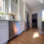 Warm Wood Floors Paired with White and Dark Grey (Iron Ore SW) cabinets