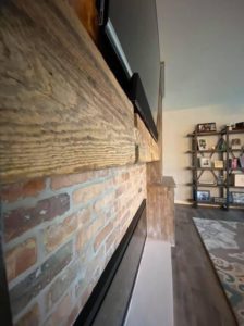 Vintage Brick Entrainment Wall Paired with Reclaimed Wood Mantle